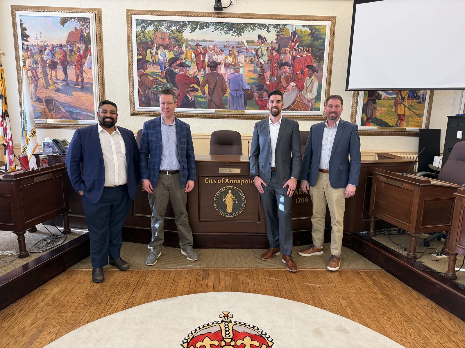 The Harbor View Consulting engagement team standing at the dais in the City of Annapolis Council Chamber